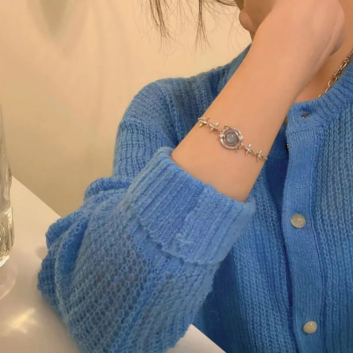 Woman wearing silver planet bracelet