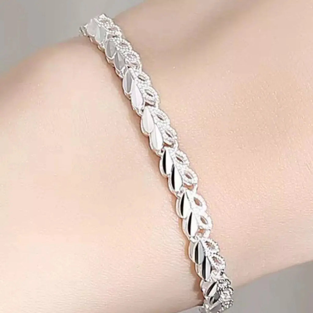 Close-up of heart link detail on silver bracelet