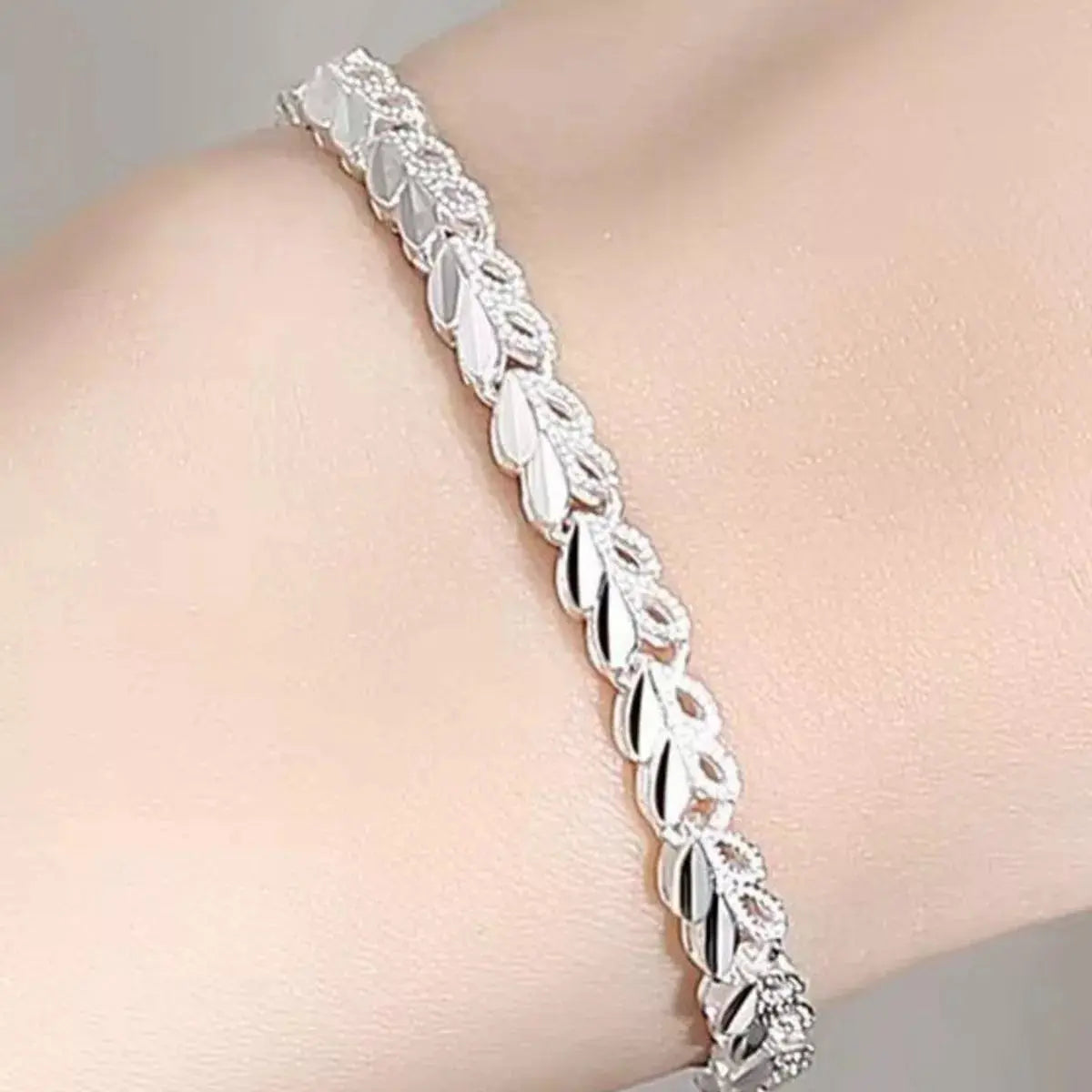 Close-up of heart link detail on silver bracelet