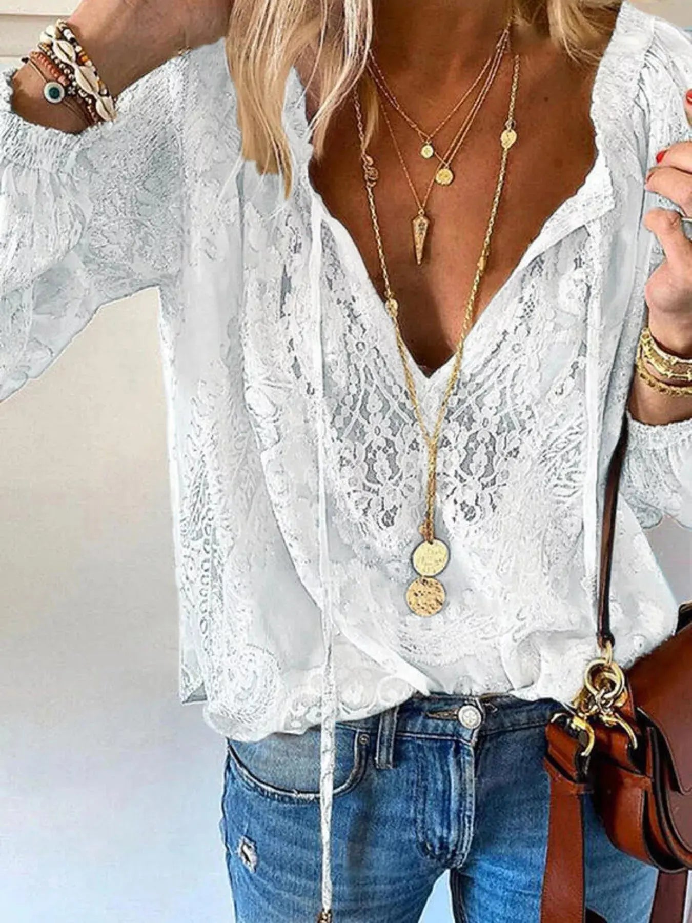 Close-up of lace detailing on tie-neck blouse