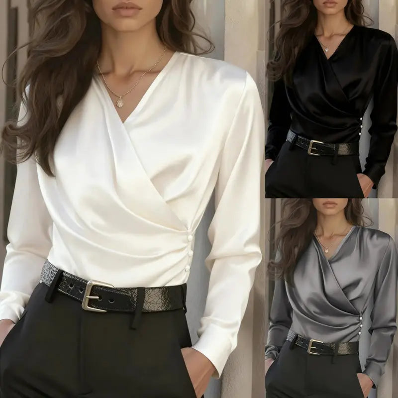 Woman wearing a white long-sleeve top with a draped design, black pants, and a belt.