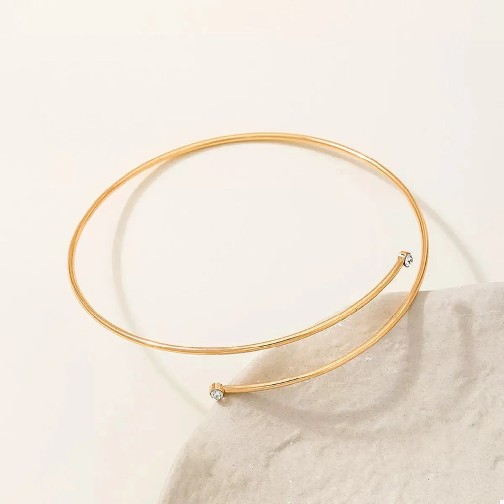 Woman wearing gold wire upper arm bracelet