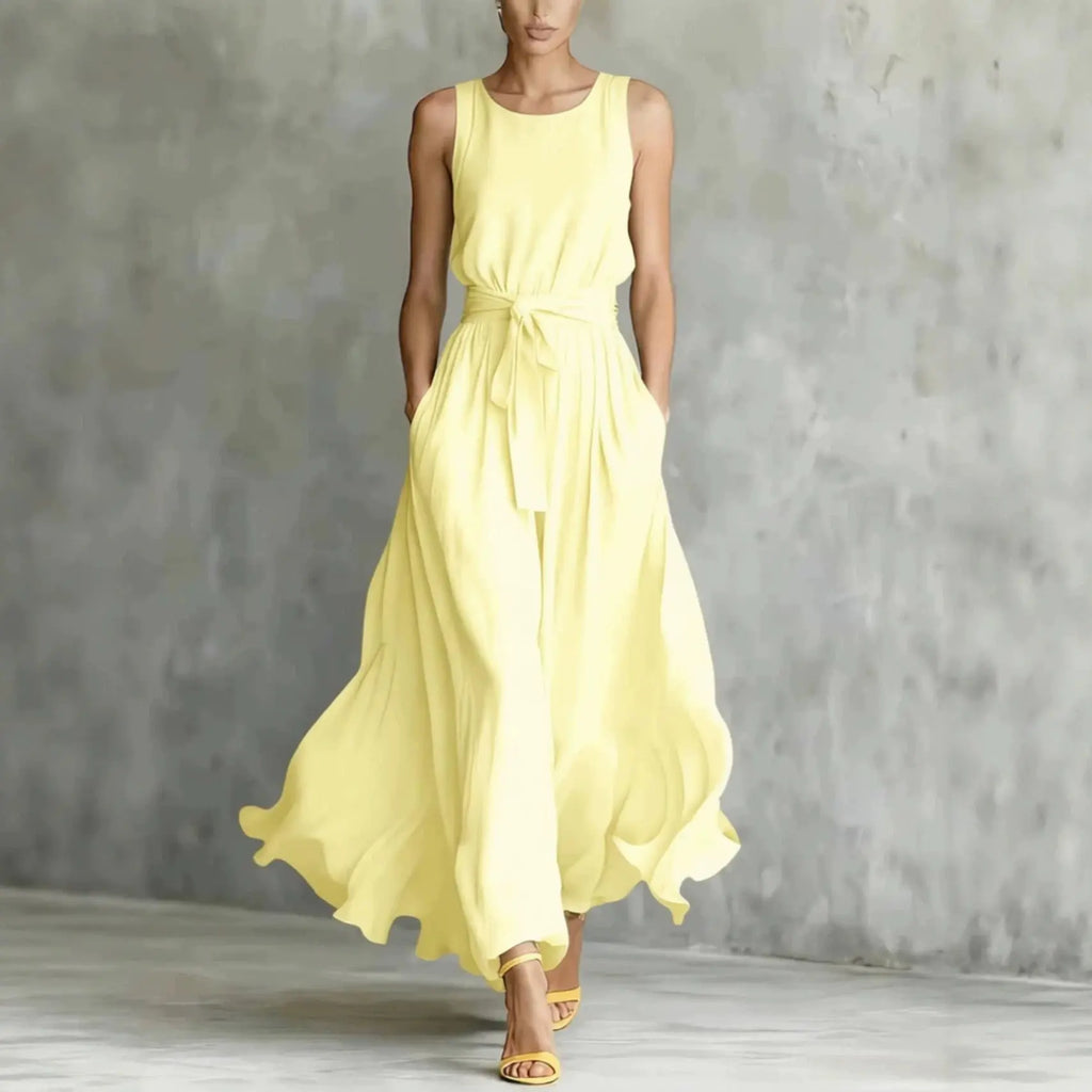 Woman wearing a yellow dress against a gray background