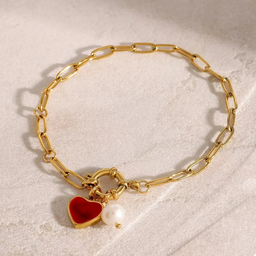 Close-up of heart charm on gold bracelet