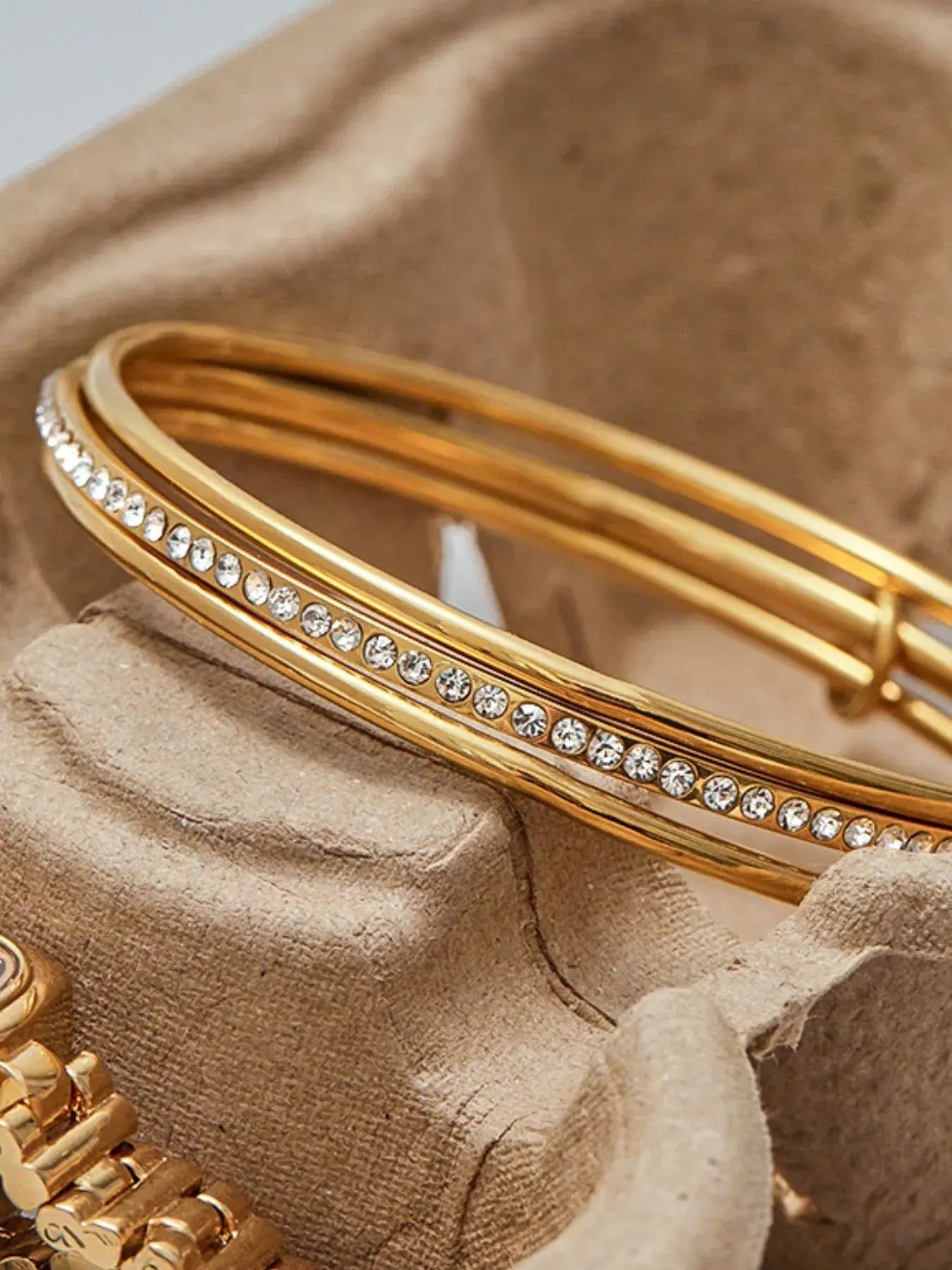 Woman wearing gold crossover zircon bracelet