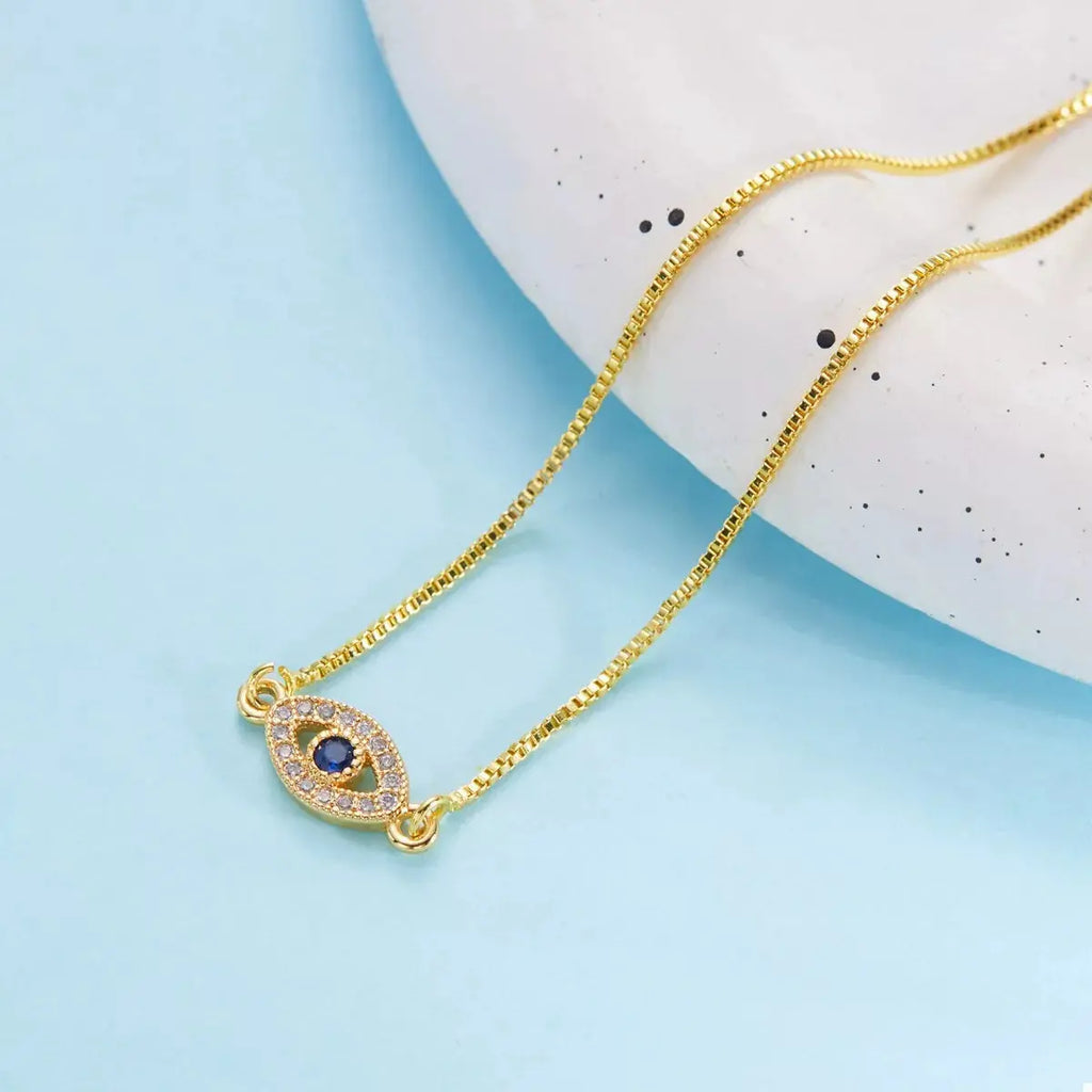 Woman wearing gold evil eye bracelet