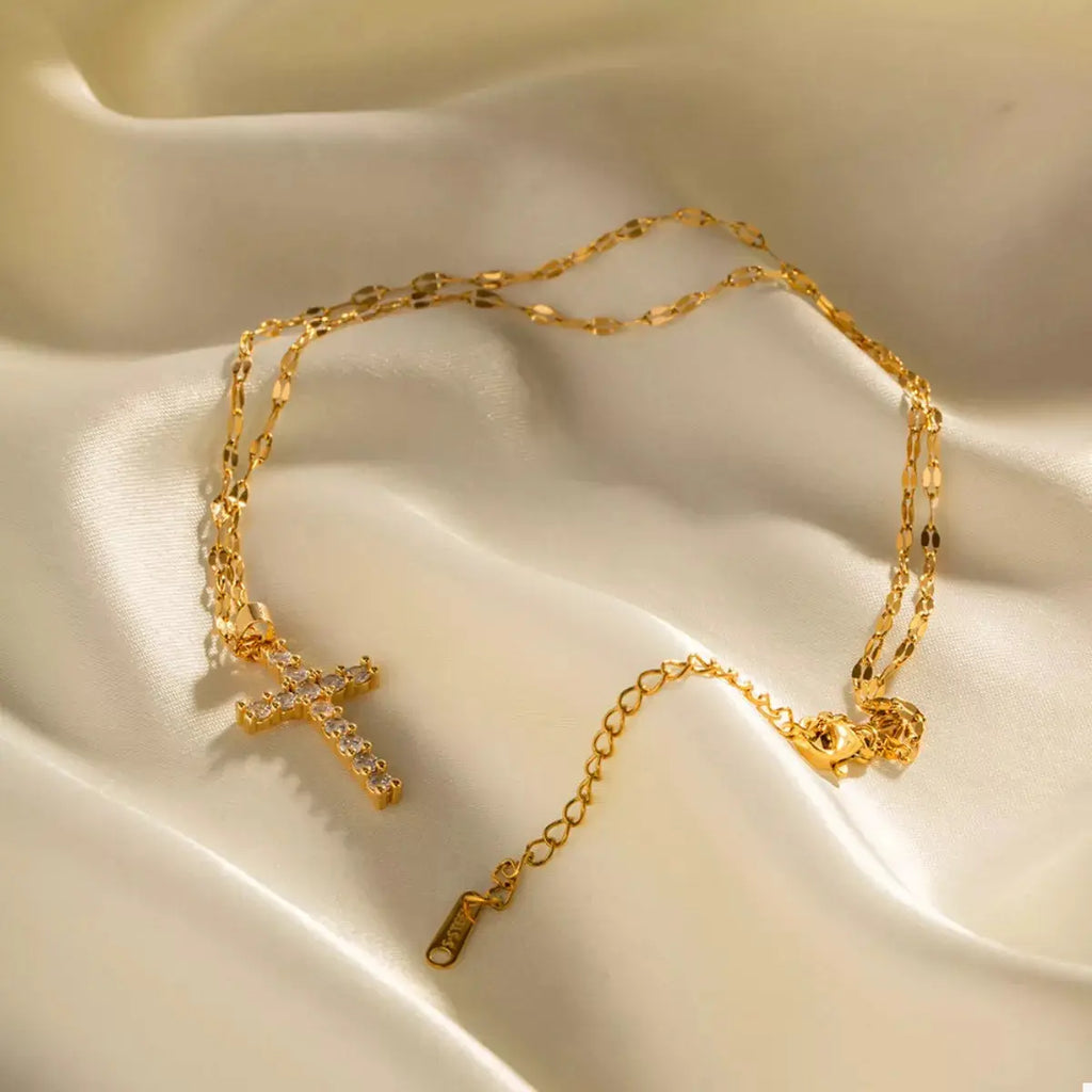 Close-up of cross pendant on gold necklace