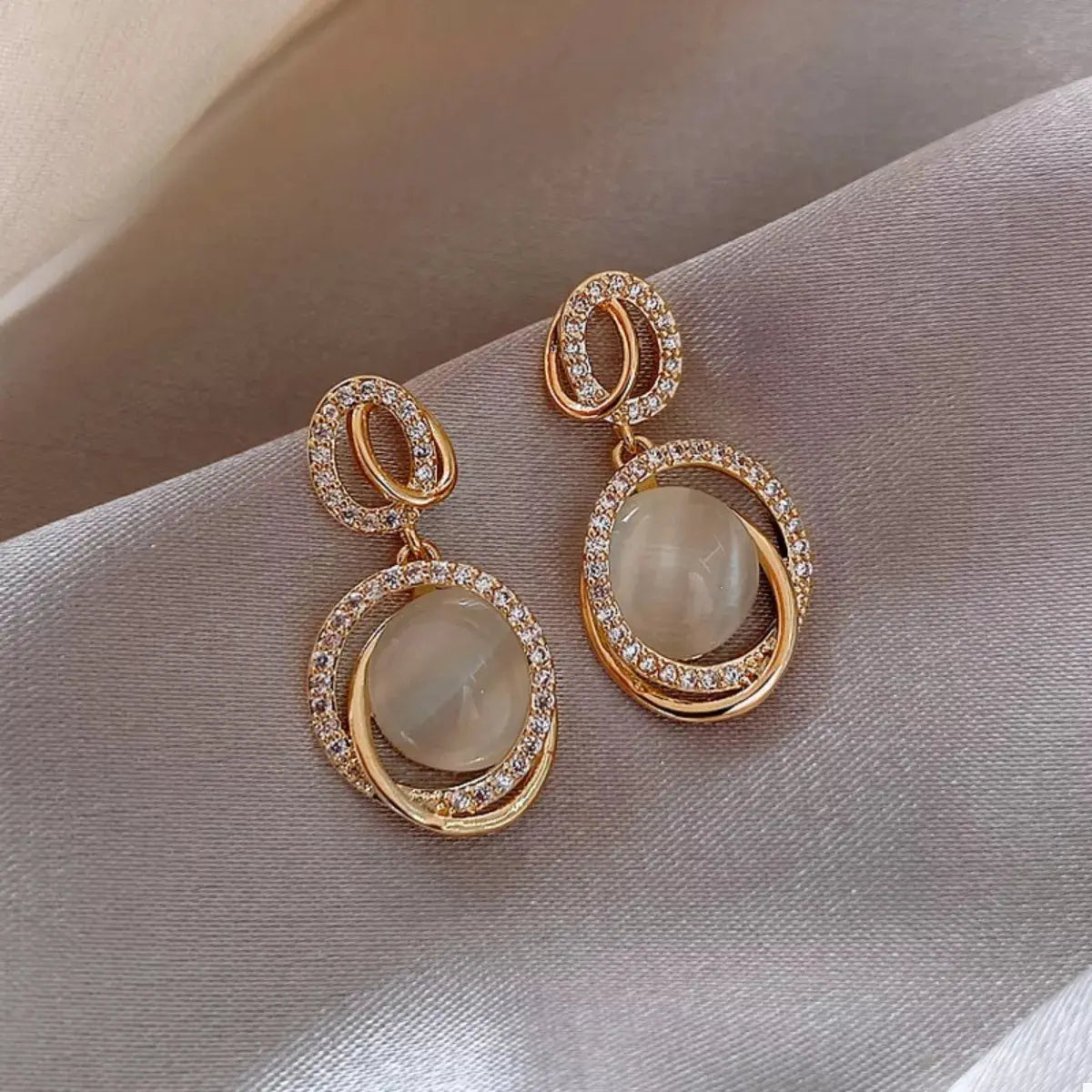 Woman wearing gold dangle earrings