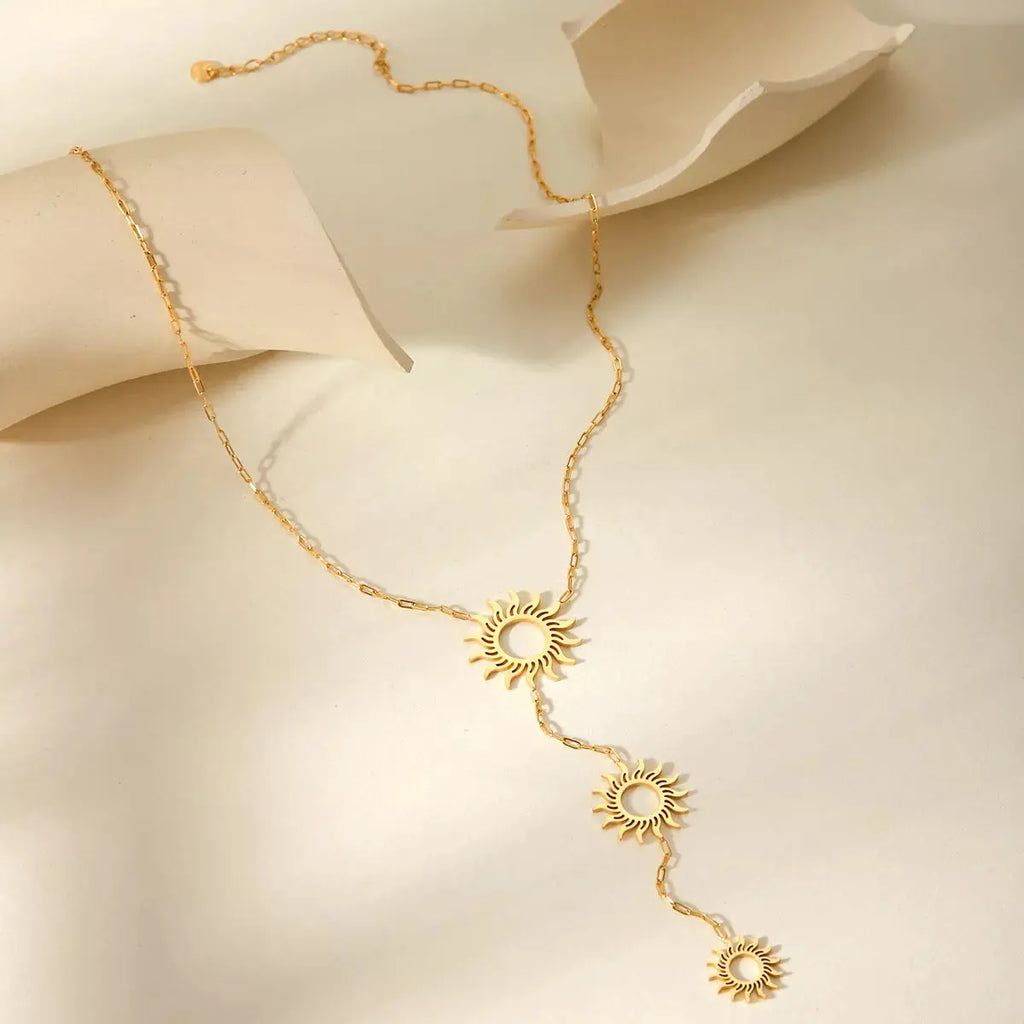 Woman wearing gold sun pendant necklace
