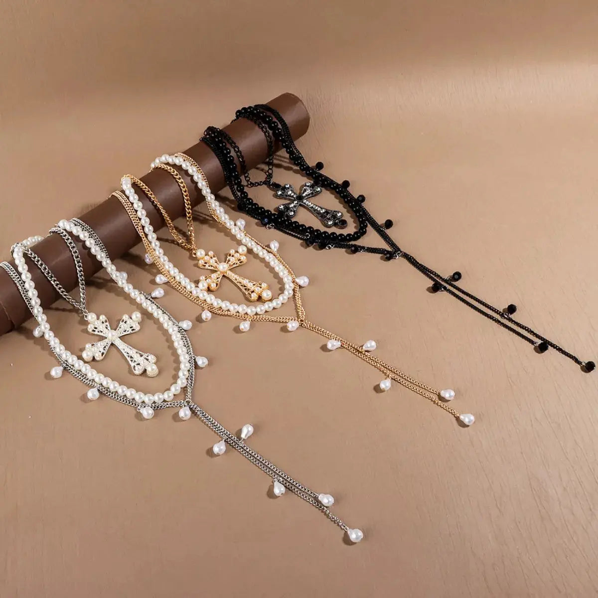 Close-up of pearl cross pendants in layered set