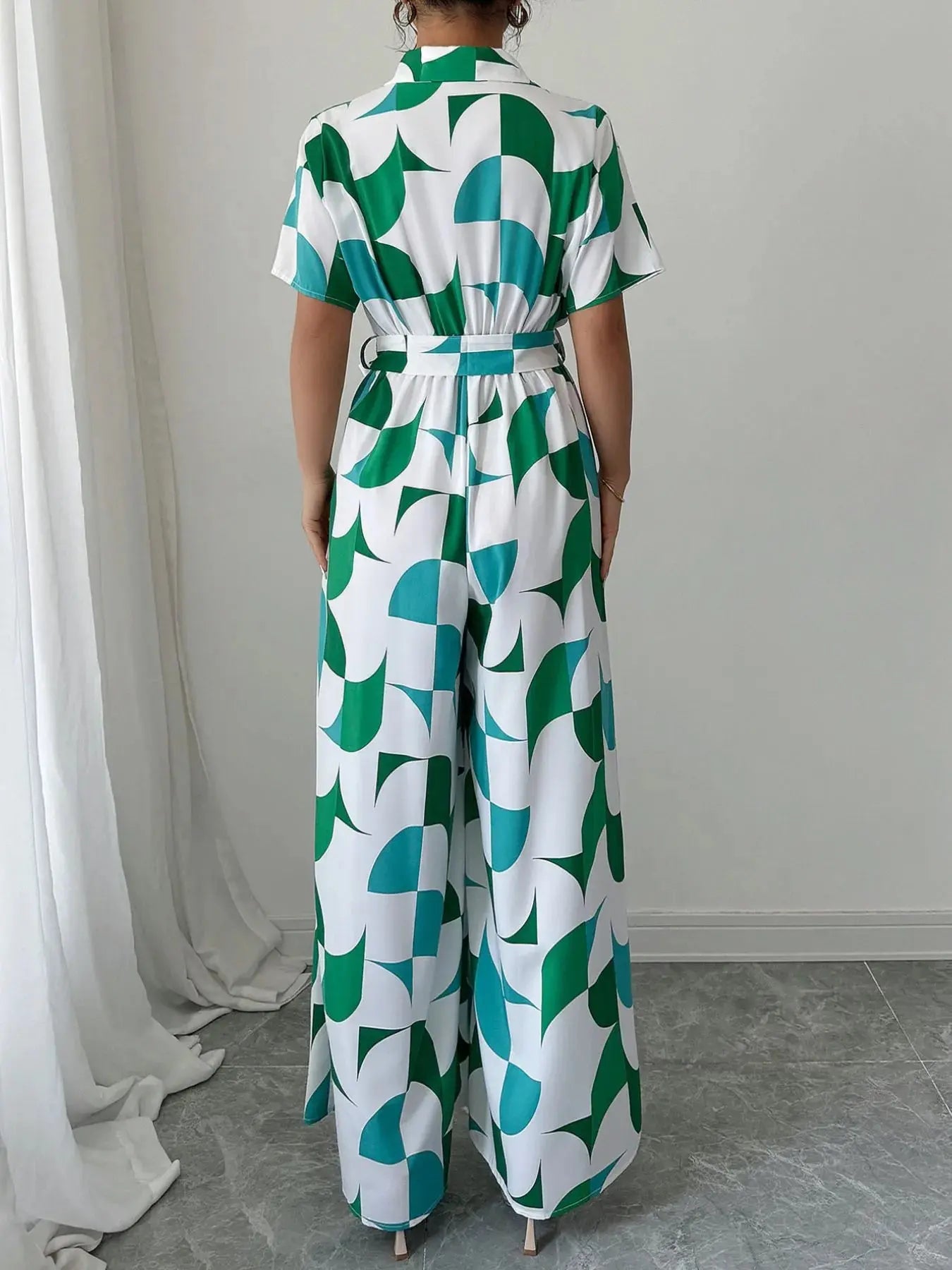 Close-up of waist belt detail on printed jumpsuit