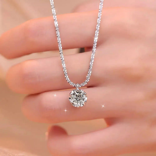 Close-up of moissanite stone on silver necklace Vicsxox.com