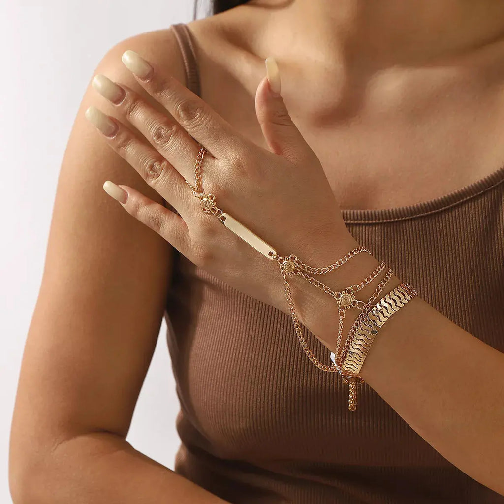 Close-up of finger ring attachment on layered bracelet