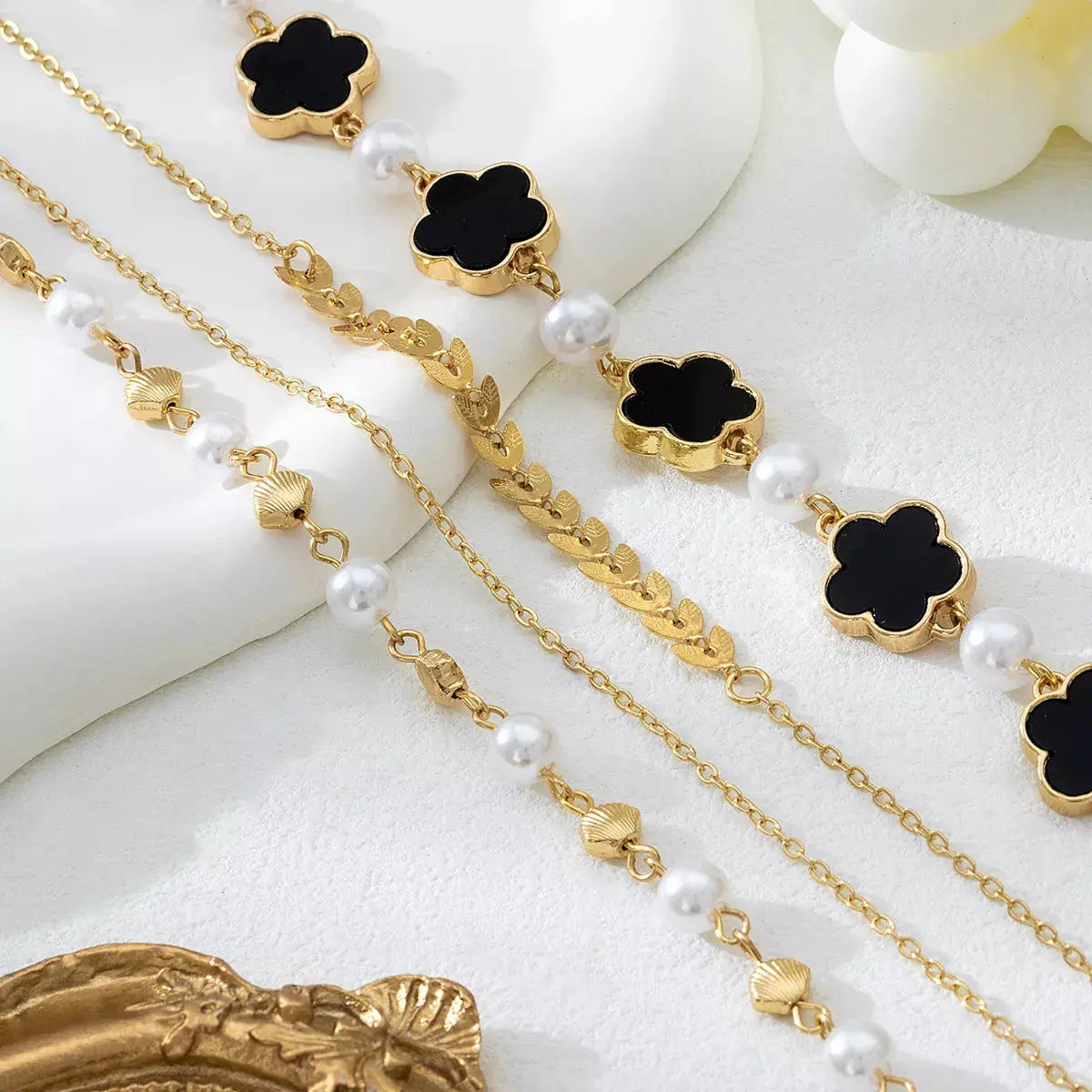 Woman wearing 4-piece gold bracelet set