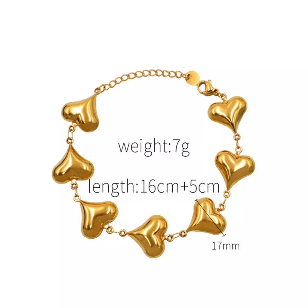Woman wearing gold heart charm bracelet