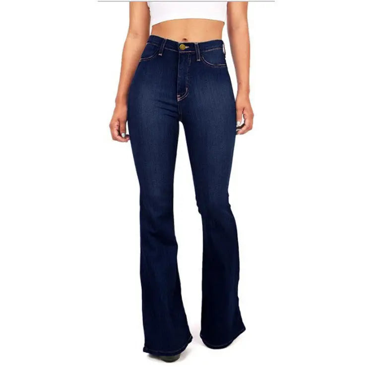 Dark blue flared jeans worn by a person on a white background