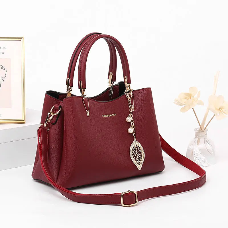 Structured vegan leather top-handle handbag styled on model