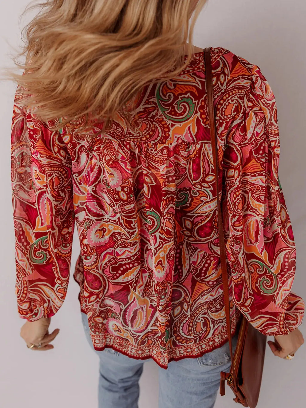 Close-up of tassel tie detail on boho paisley blouse