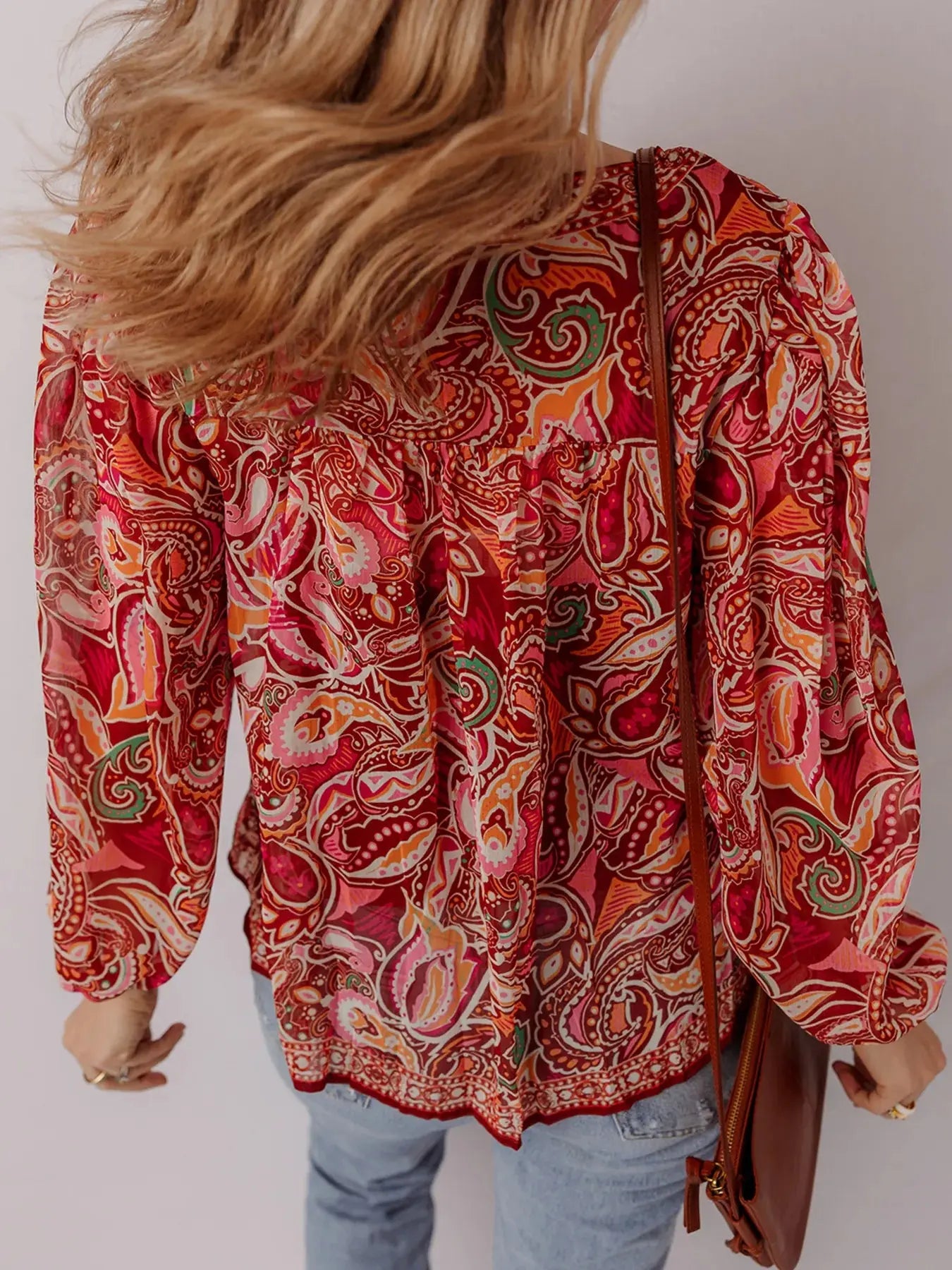Close-up of tassel tie detail on boho paisley blouse