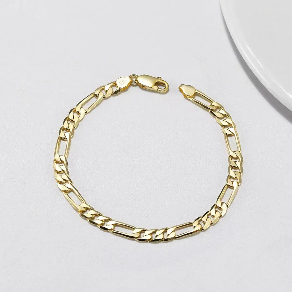 Woman wearing silver and gold chain bracelet