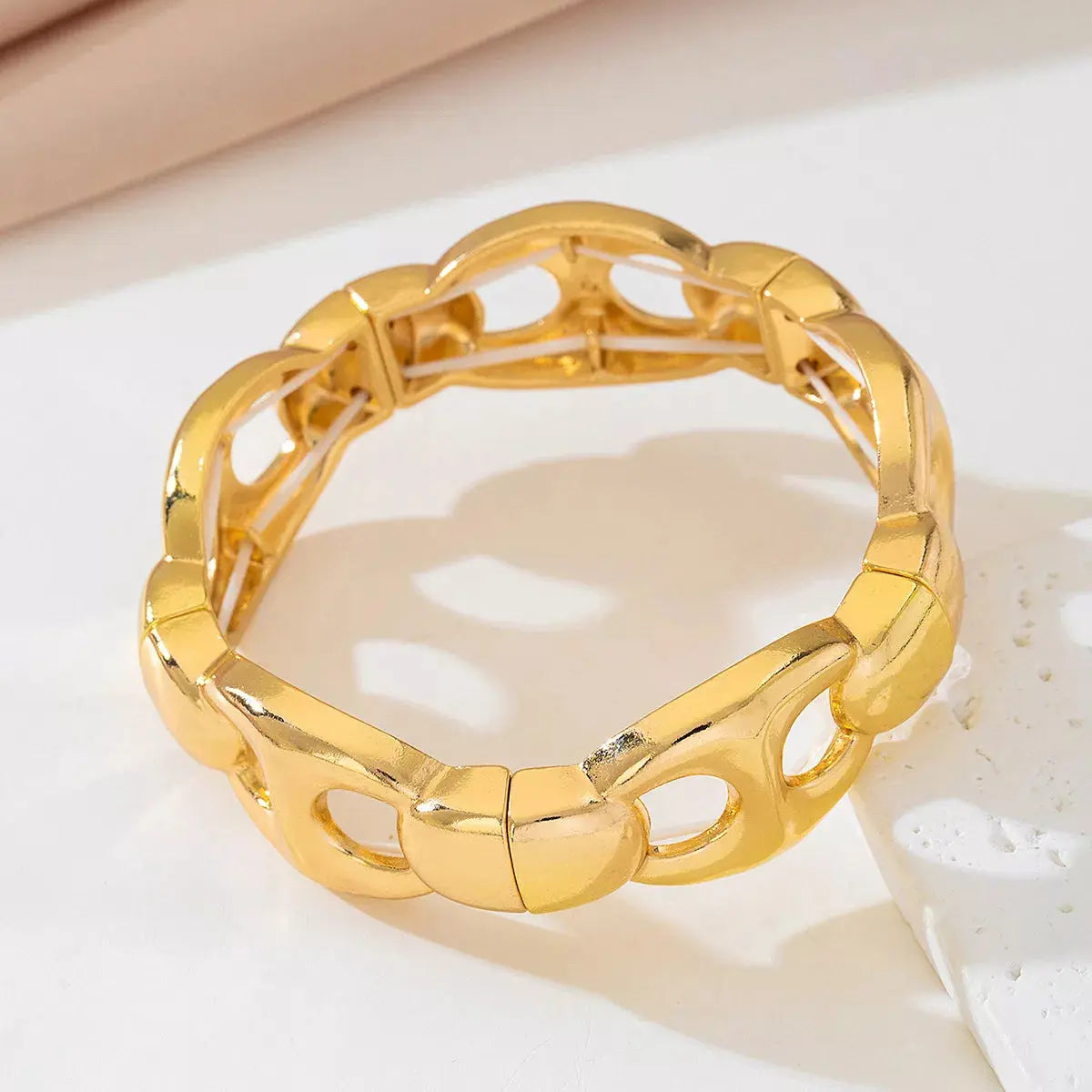 Woman wearing gold chain link bracelet