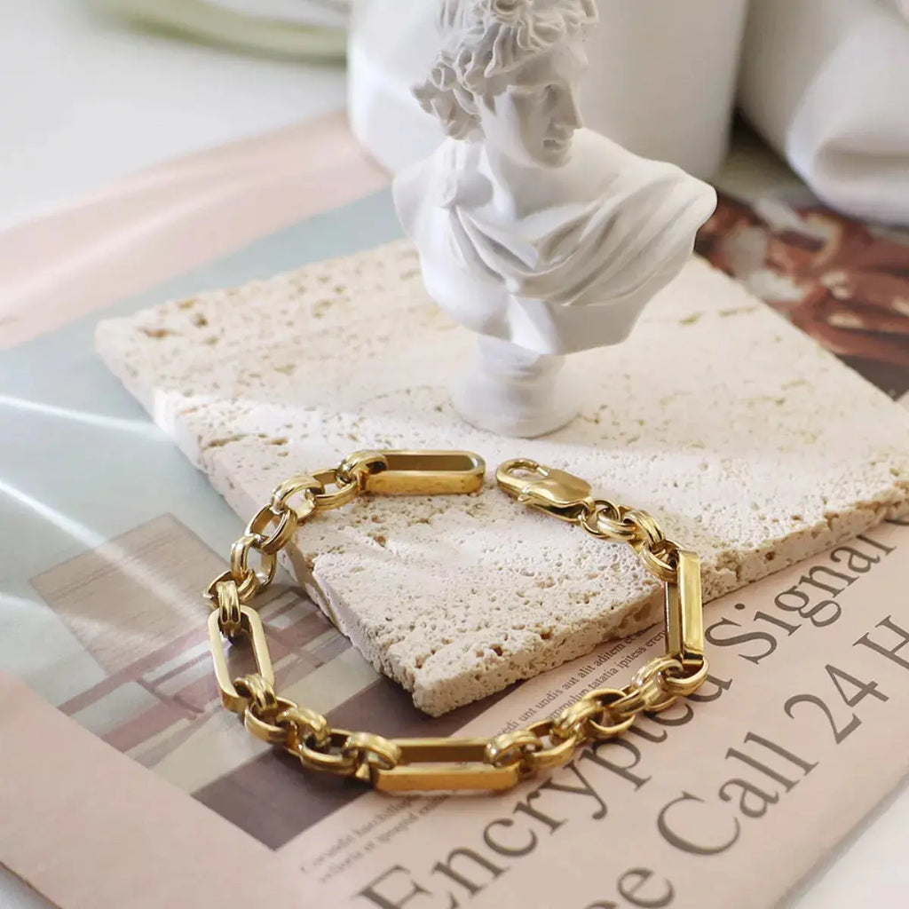 Close-up of chunky chain link detail on gold bracelet