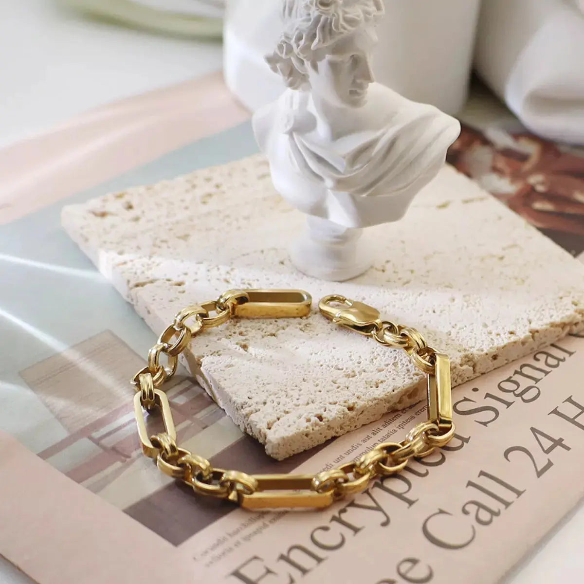 Close-up of chunky chain link detail on gold bracelet