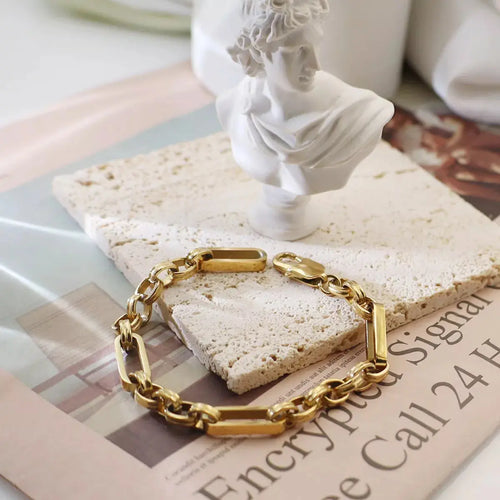 Close-up of chunky chain link detail on gold bracelet