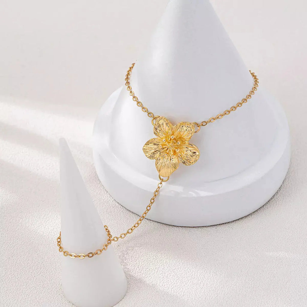 Woman wearing gold chain flower bracelet