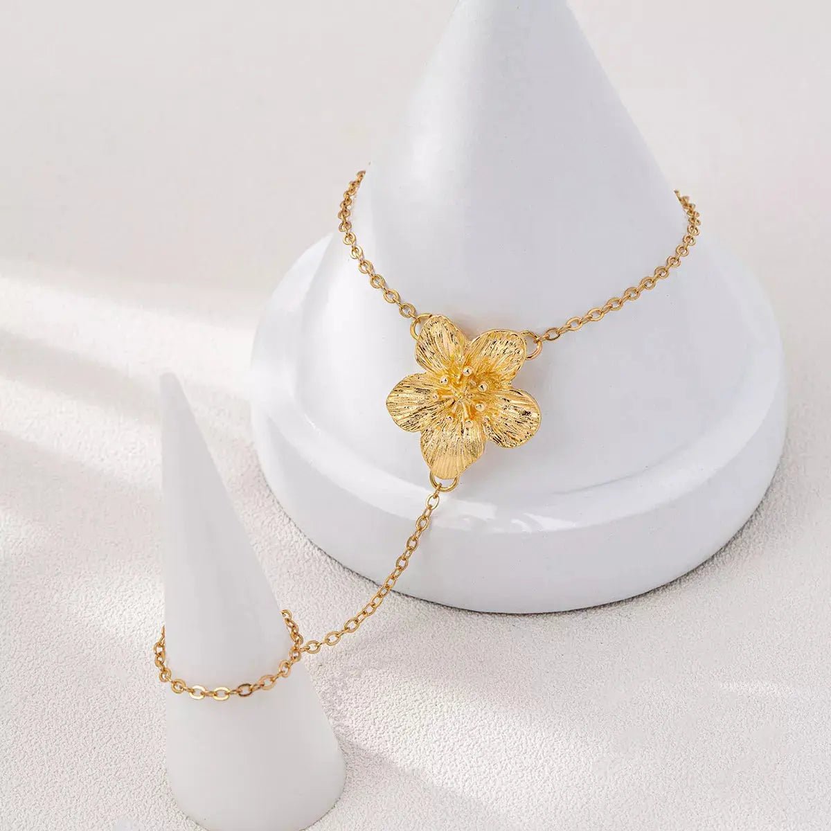 Woman wearing gold chain flower bracelet