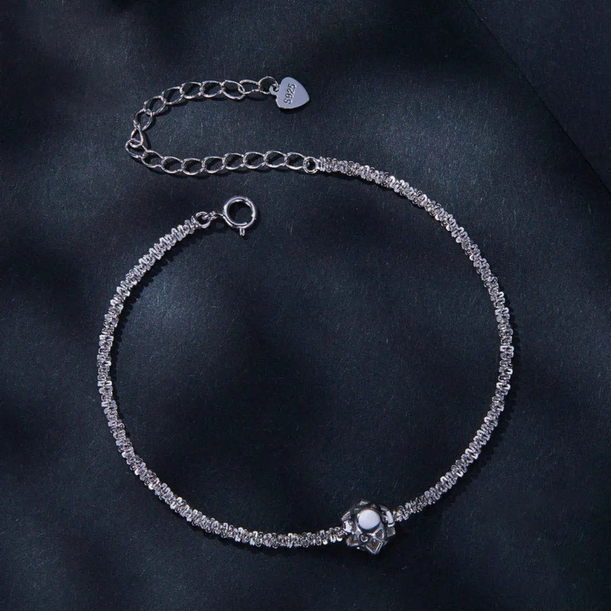 Close-up of zircon detail on silver bracelet