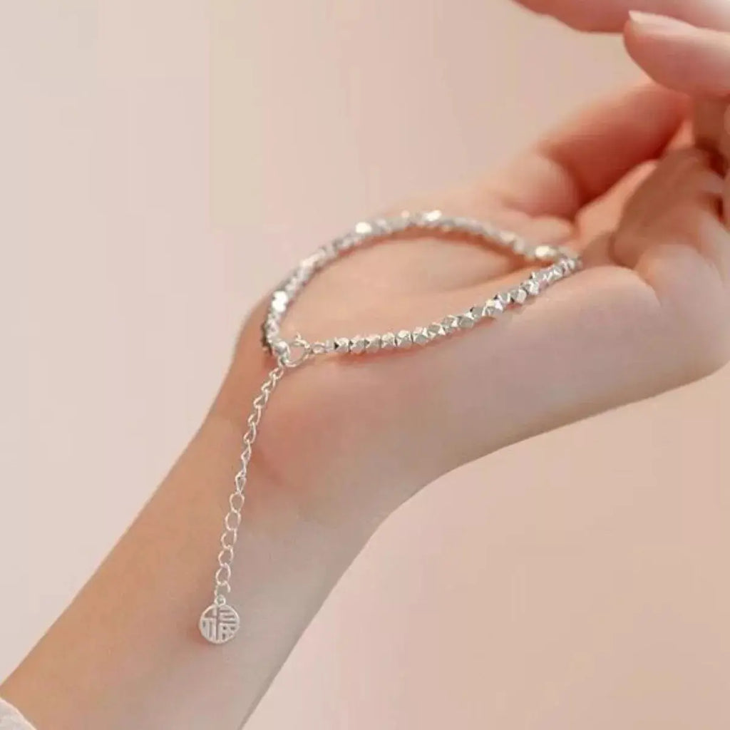 Woman wearing adjustable geometric chain bracelet