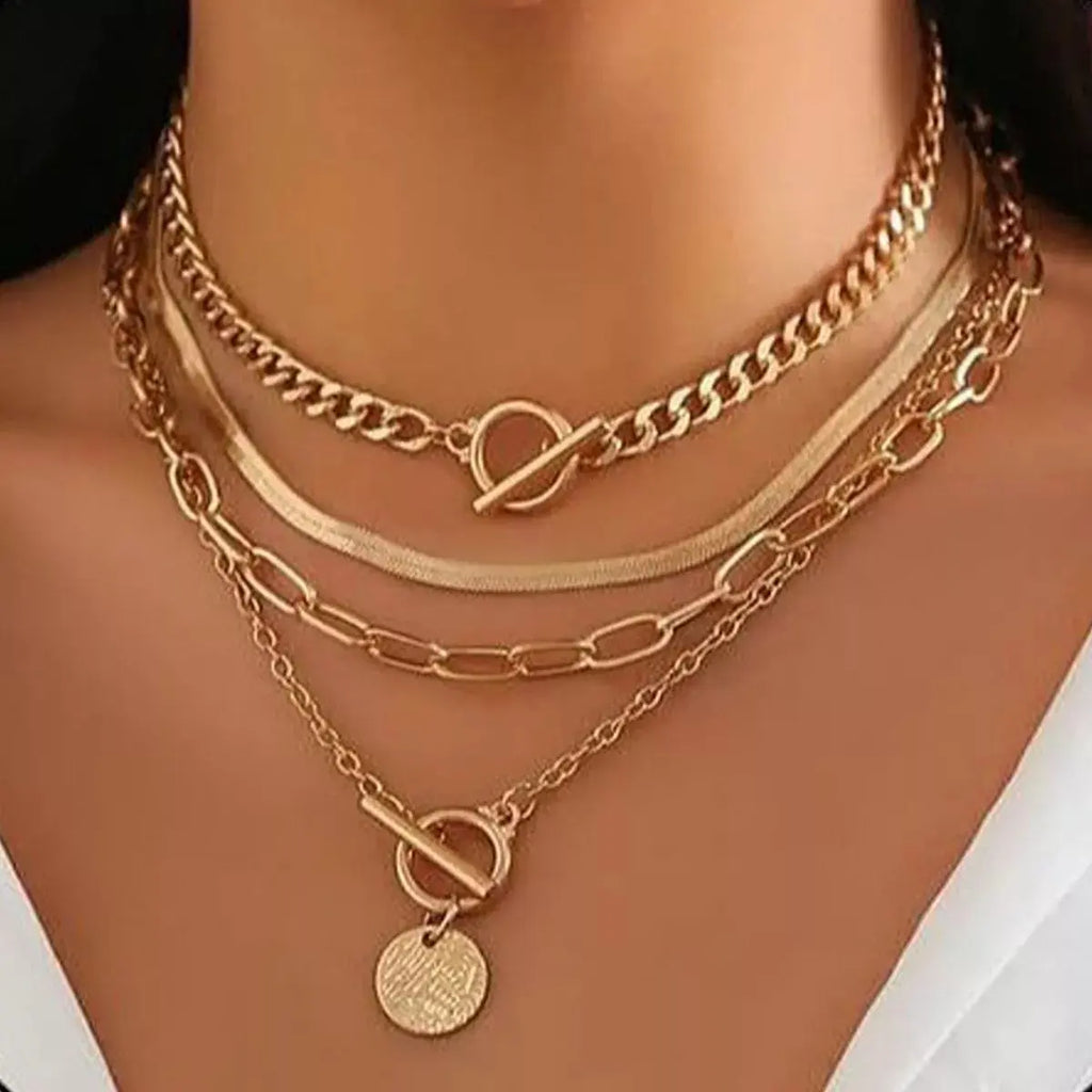 Close-up of coin pendant details on layered necklace set