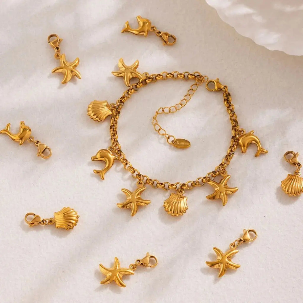 Woman wearing gold sea shell charm bracelet