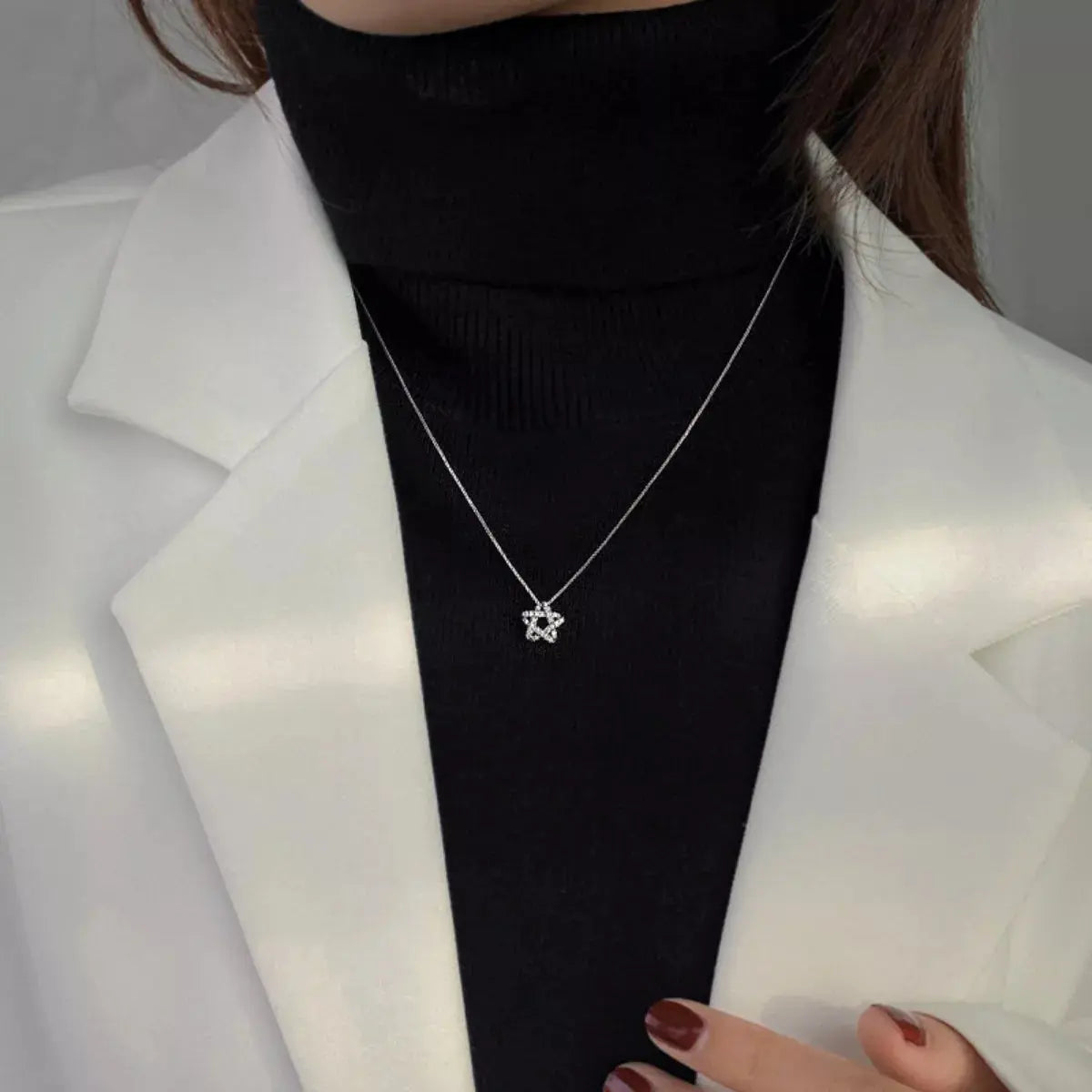 Woman wearing silver zircon star necklace