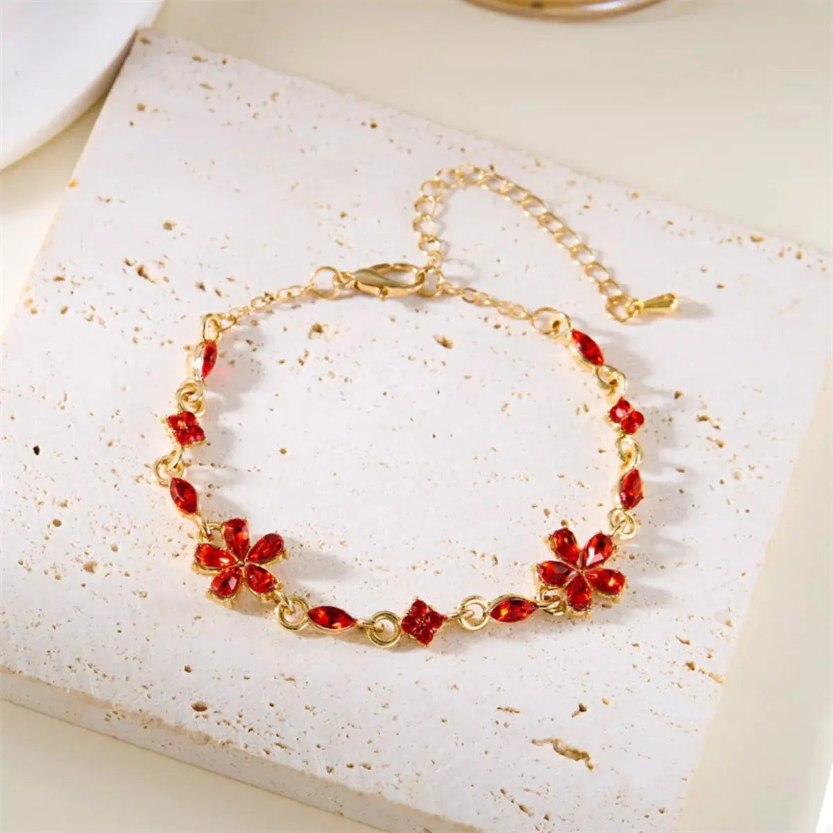 Close-up of flower and rhinestone detail on gold bracelet
