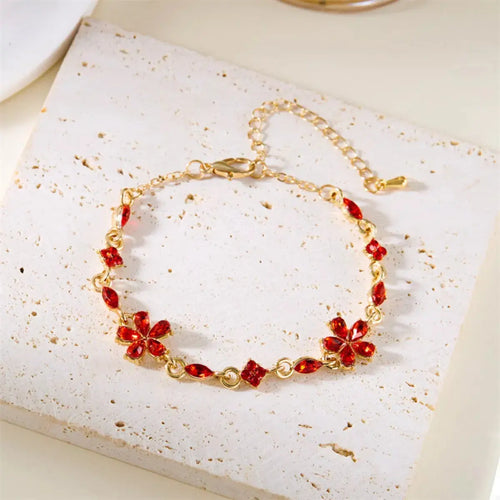 Close-up of flower and rhinestone detail on gold bracelet