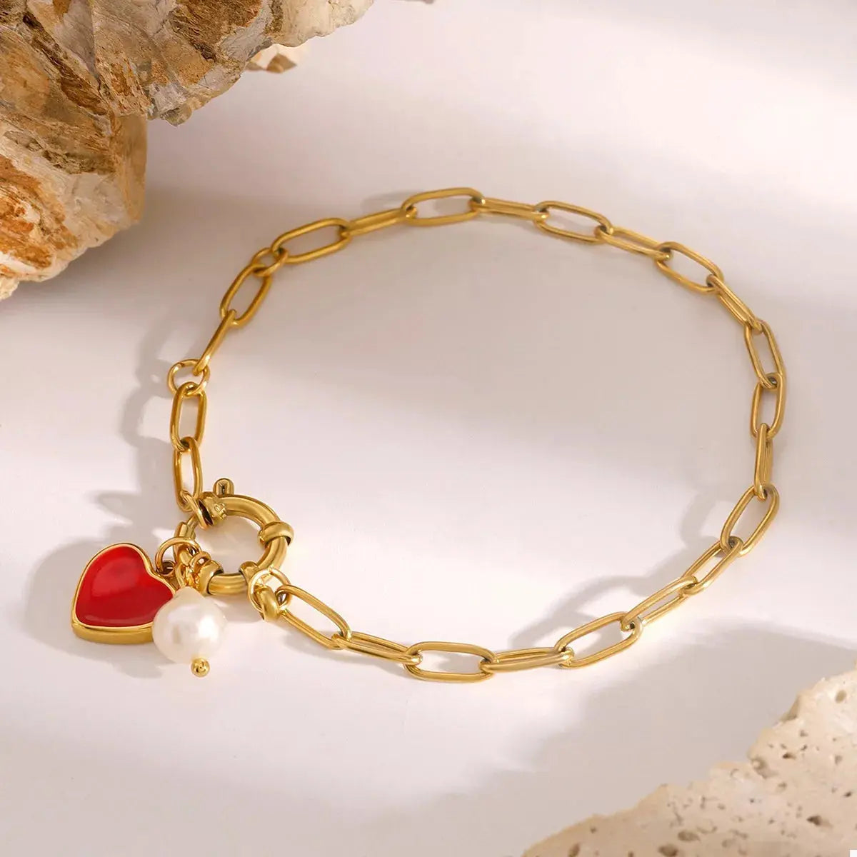 Woman wearing gold heart charm bracelet