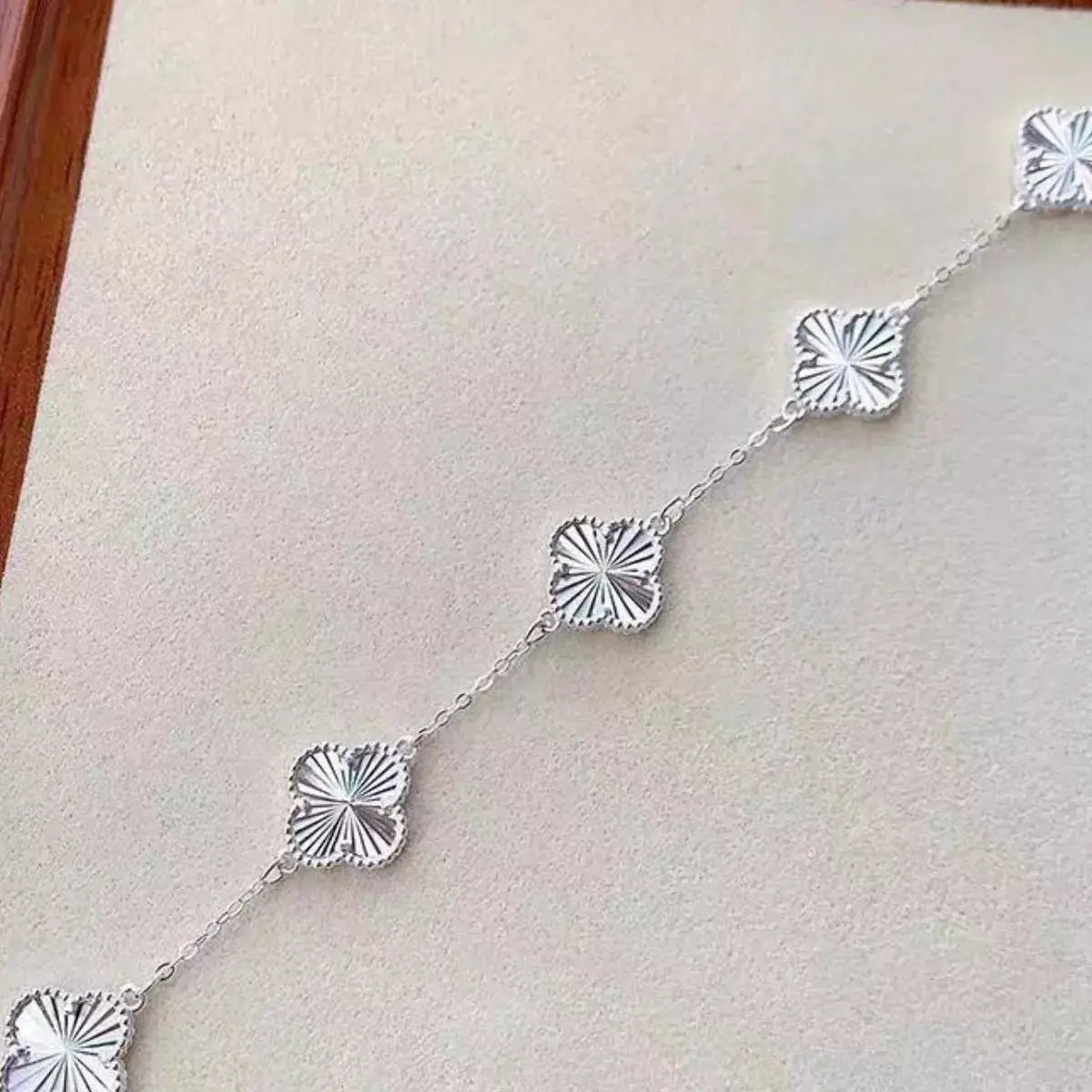 Woman wearing silver clover chain bracelet