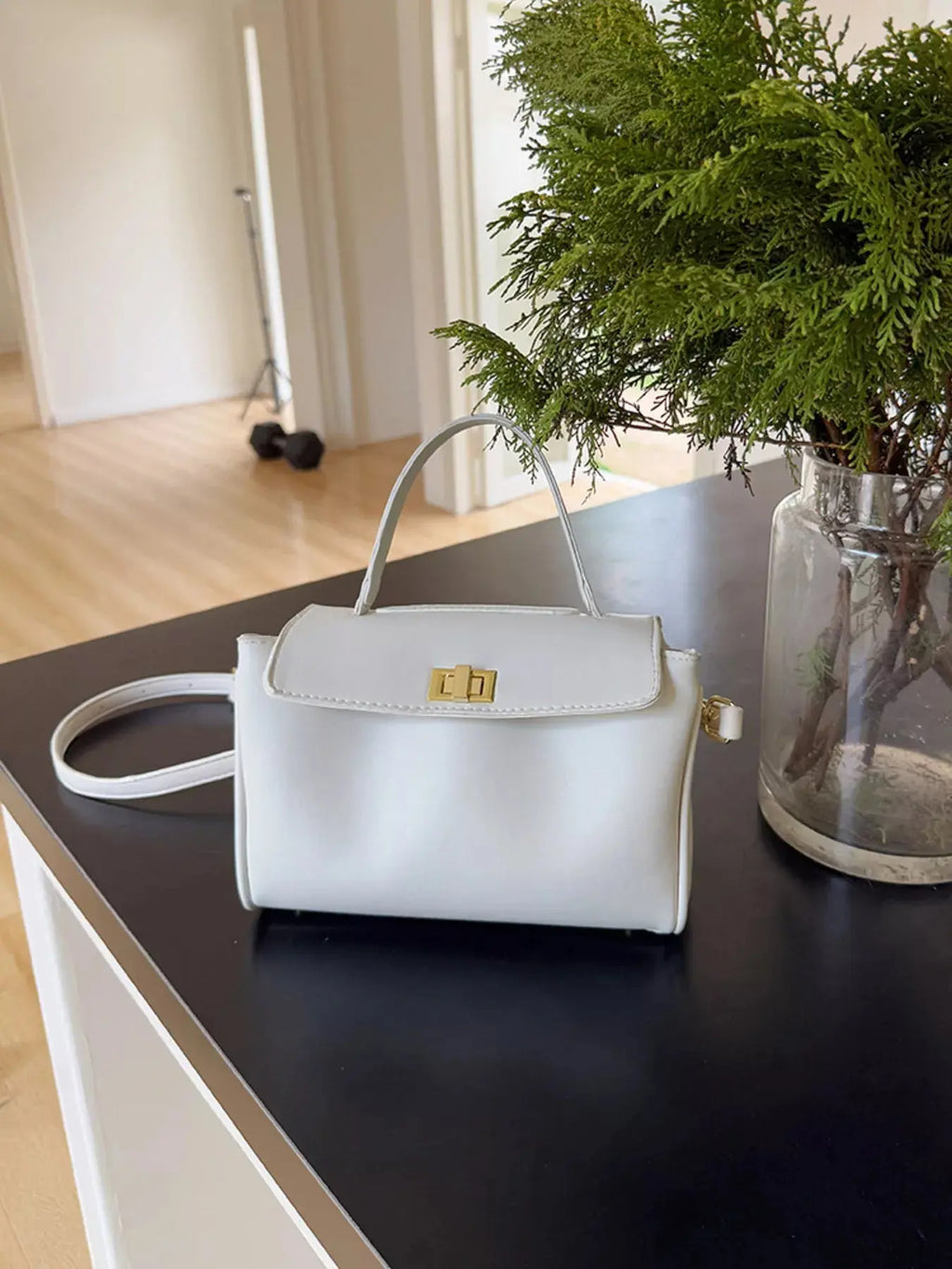 Gold twist-lock structured crossbody bag, front view
