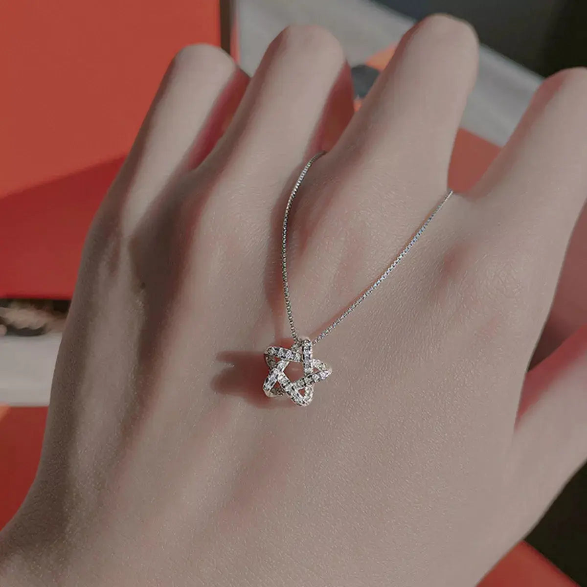 Close-up of star pendant with zircon accents