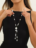 Elegant pearl and rose pendant necklace, front view