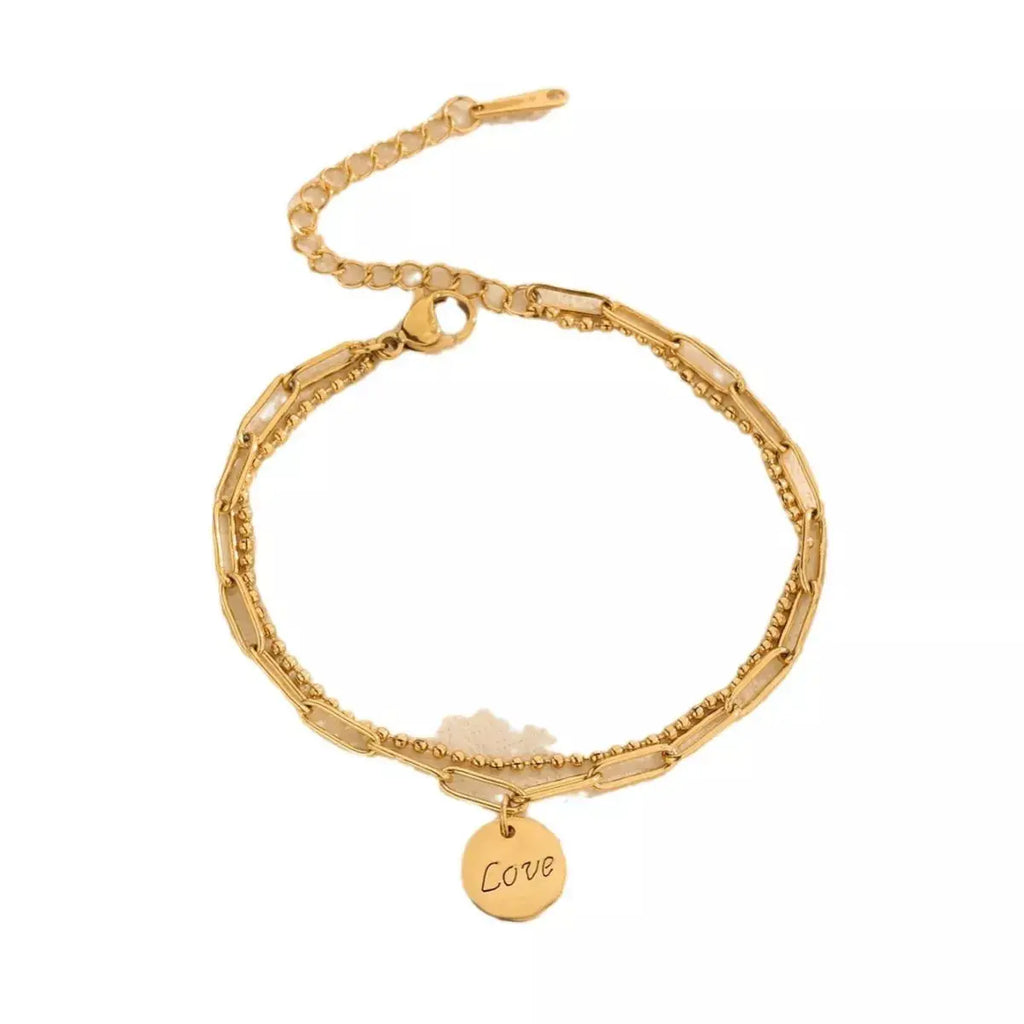 Woman wearing gold LOVE charm bracelet