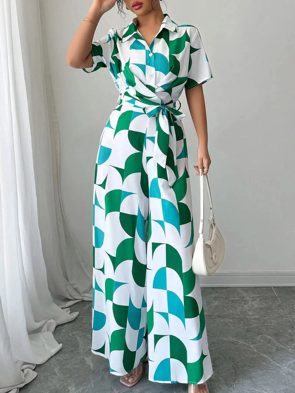 Full length view of printed belted jumpsuit