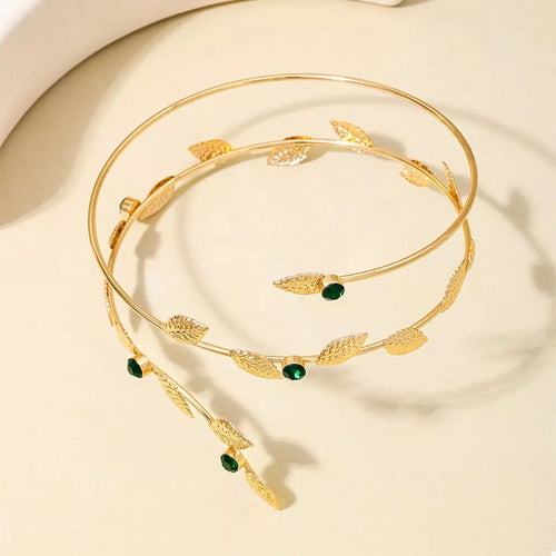 Close-up of leaf and rhinestone detail on gold bracelet