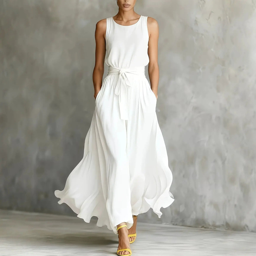 Woman wearing a white sleeveless dress against a gray background