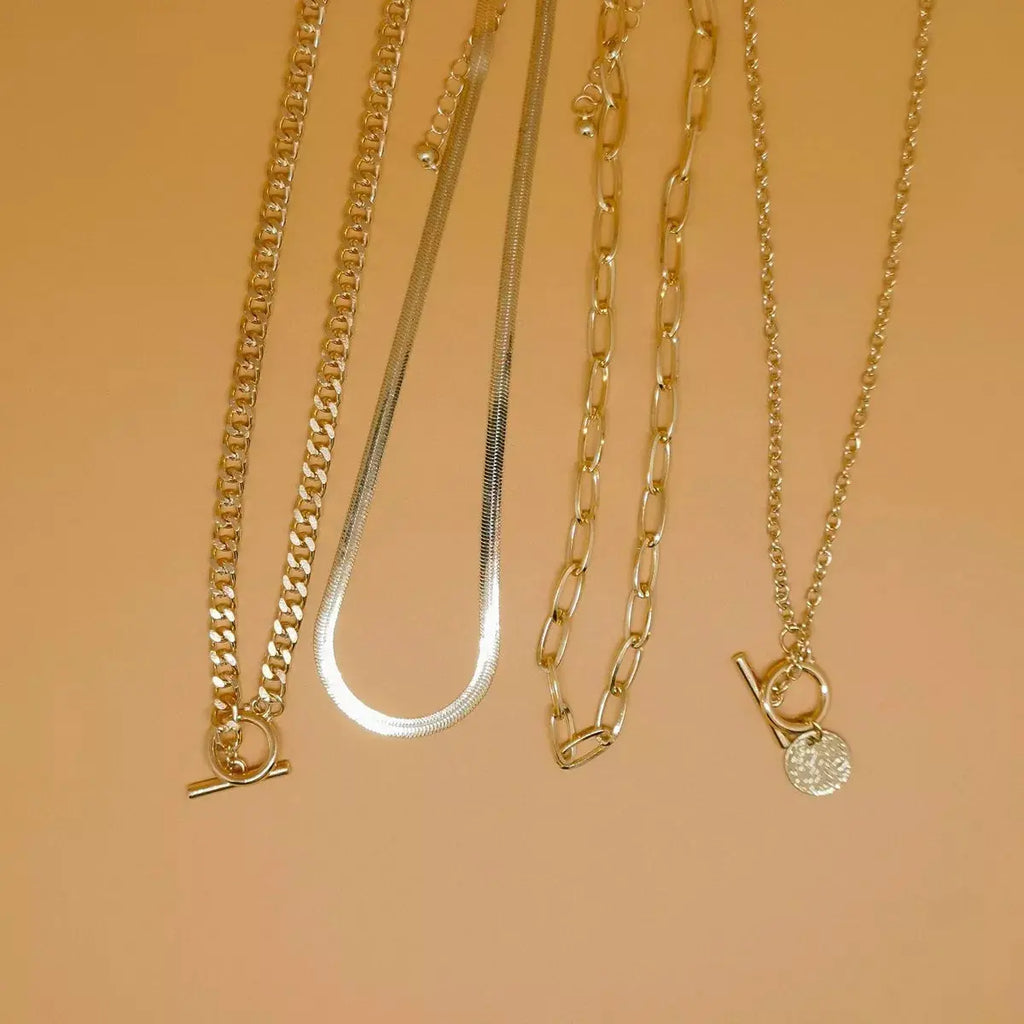 Woman wearing layered coin pendant necklace set