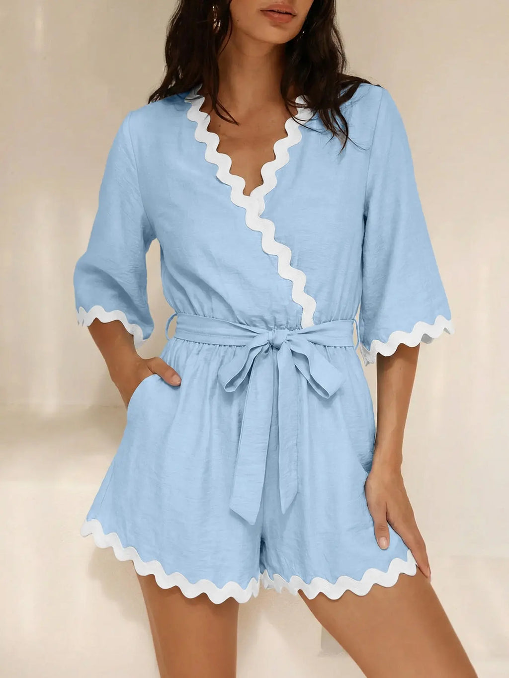 Close-up of scalloped trim on wrap romper
