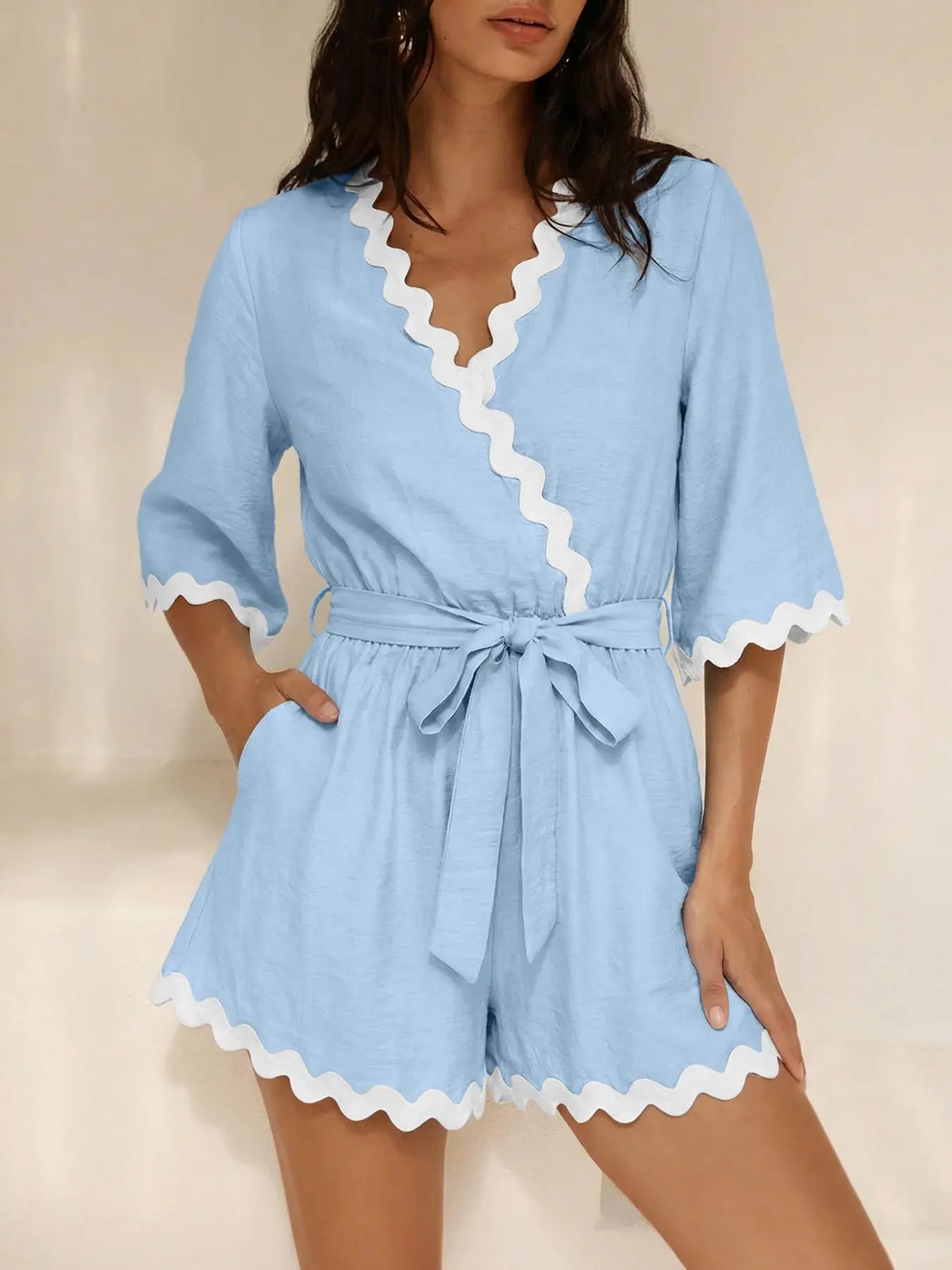 Close-up of scalloped trim on wrap romper