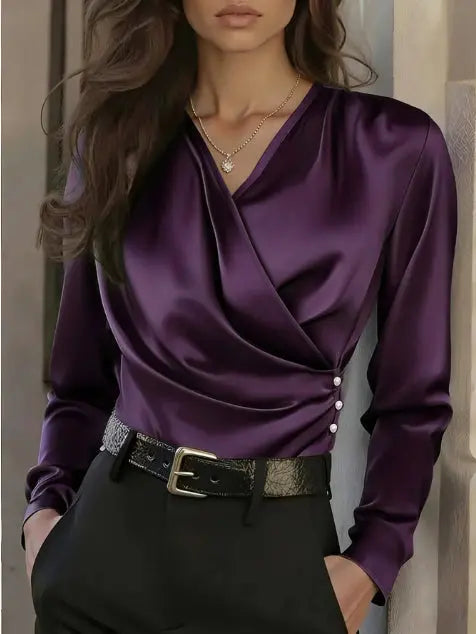Purple satin blouse worn by a person with a neutral background